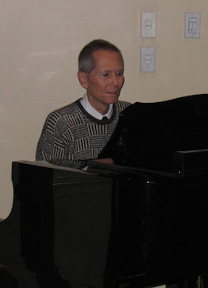 Bud Brewster playing the piano during his presentation at the November 2006 MWSCC dinner meeting.