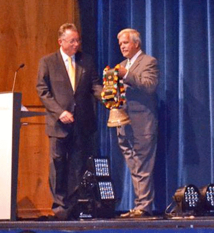 Auderset presented a traditional Swiss cow bell to U.S. SCC president Tony O'Lenick as a symbol of the Secretariat's move to New York.
