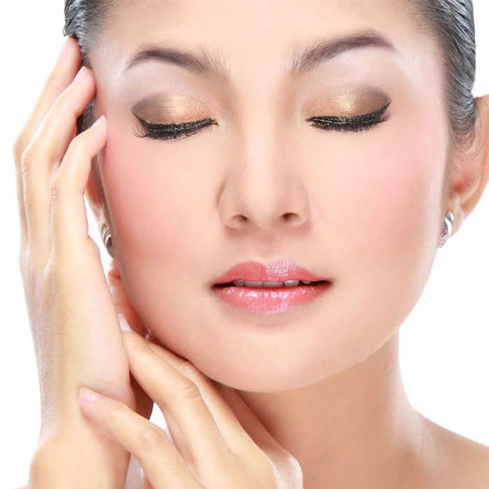 Asian-woman-eyes-closed-hands-on-face-850