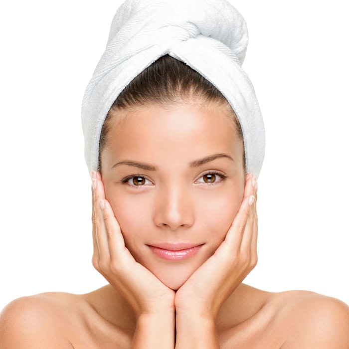 Woman-in-towel-rubbing-face-850