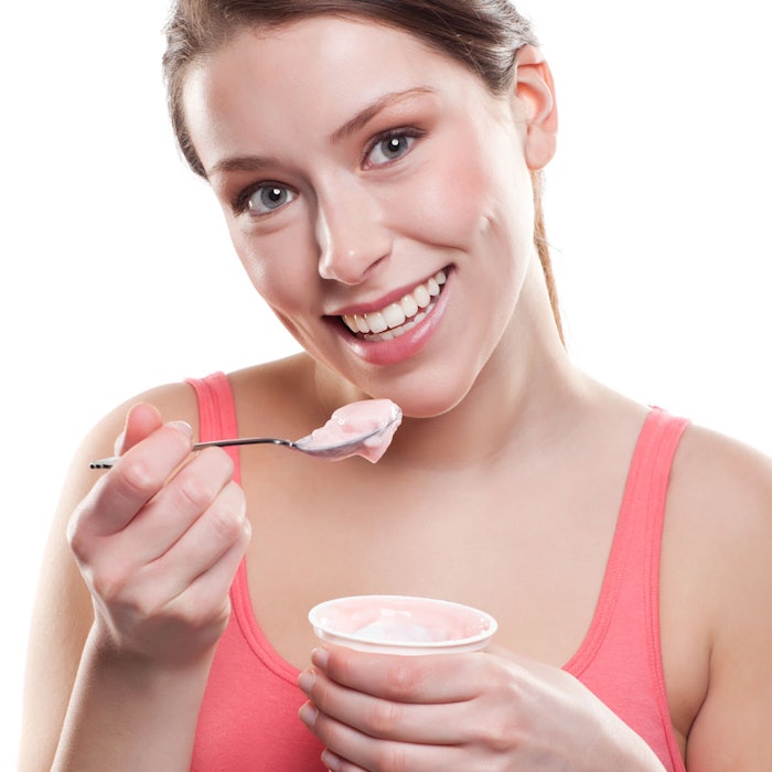 WomanSmilingEatingYogurt850