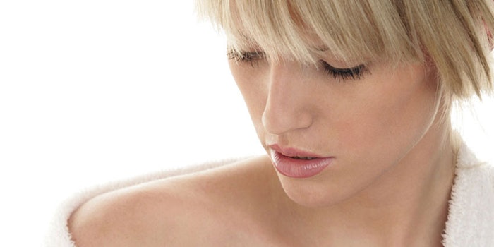 WomanExaminingSkin850x425