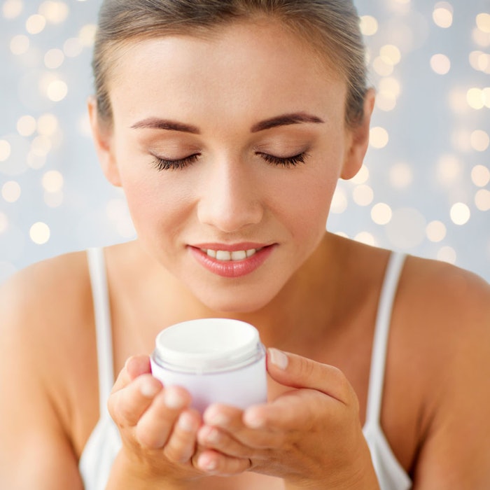 WomanSmellingCreamJar850