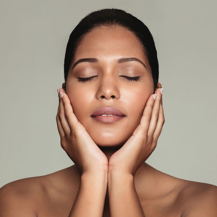 BronzeWomanTouchingFace850