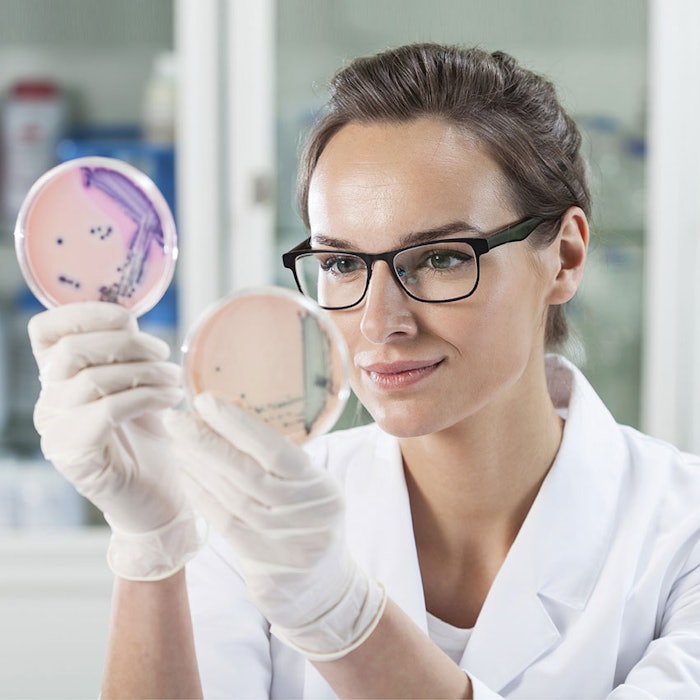 WomanResearcherMicrobePetriDishes850