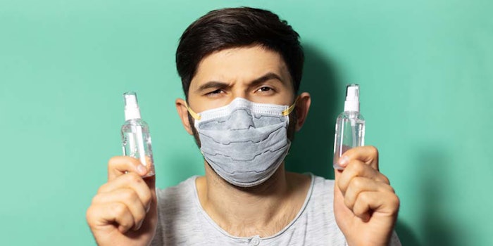 ManHoldingTwoBottlesHandSanitizer850x425