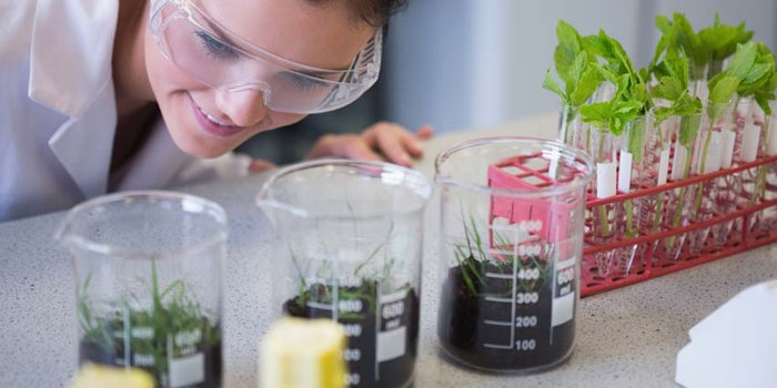 WomanChemistinLabPlantsBeakersSolution850x425