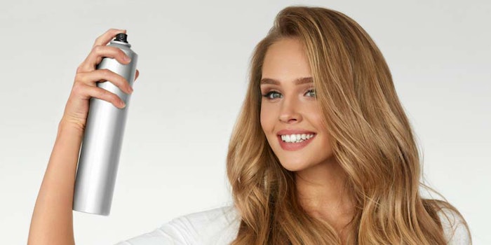 WomanSprayingHairVolume850x425