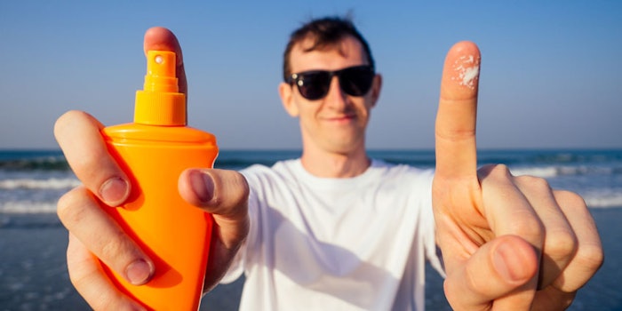 ManonBeachHoldingSpraySunscreenGlassesSmilingFrontalPerspective_850x425