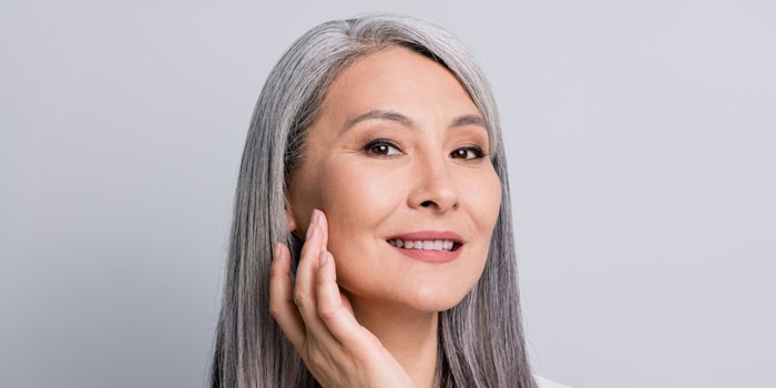 MatureAsianWomanSmilingTouchingCheek_KaoCorp_NasolabialFolds_850x425