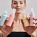 WomanTattooedArmsHoldingMultipleBottlesofLotions_850x425