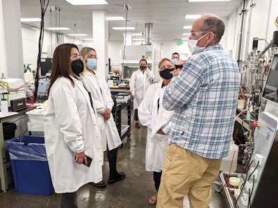 Foreground, left to right: Algenist CEO Rose Fernandez and Checkerspot CSO Scott Franklin on a tour at Checkerspot HQ in Alameda, California.