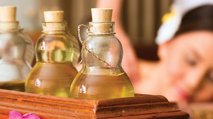 Woman getting essential oil spa treatment