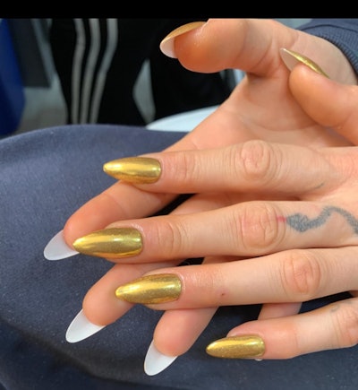 White and gold peekaboo nails on model Cara Delevingne