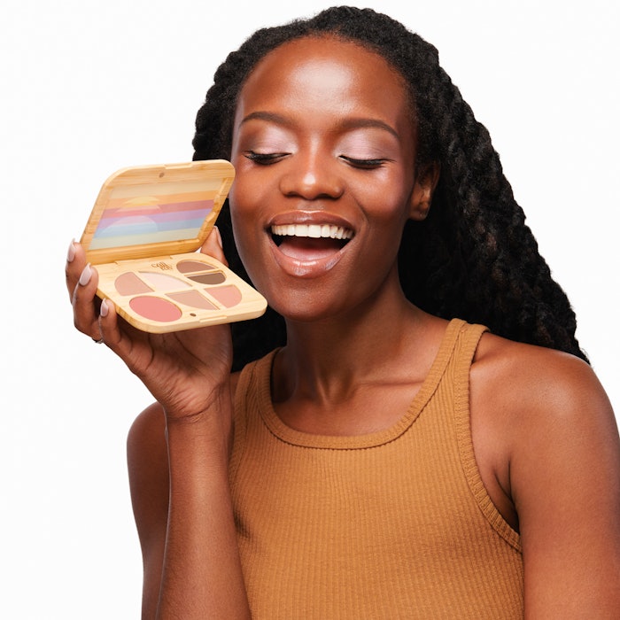 The refillable bamboo palette base has space for a reusable steel mirror and recyclable aluminum shadow pans.