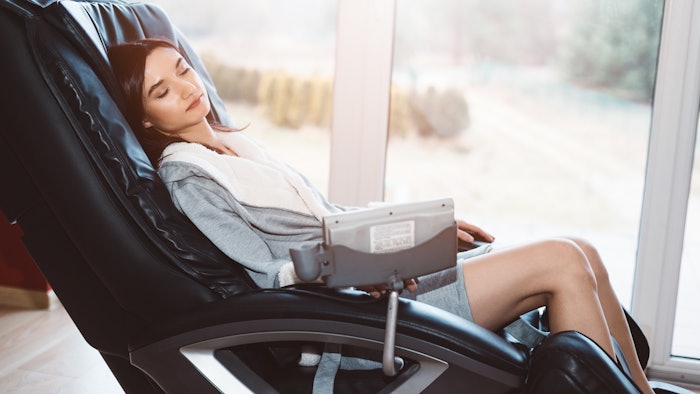 woman relaxing in massage chair lounger