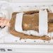 woman smiling during body mud and wrap spa treatment