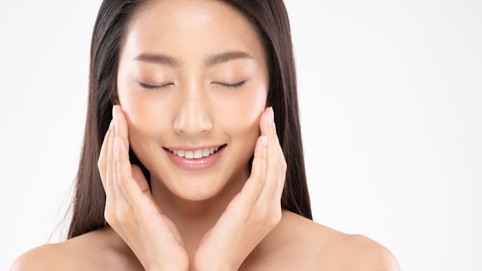 Beautiful Asian young woman touching soft cheek smile with clean and fresh skin Happiness and cheerful with positive emotional,isolated on white background,Beauty and Cosmetics Concept