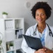 Portrait of female African American doctor standing in her office