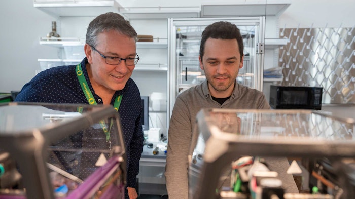 Paul Dalton and Ievgenii Liashenko demonstrate the use of an open source 3D printer that uses melt electrowriting, a printing technique developed by Dalton.