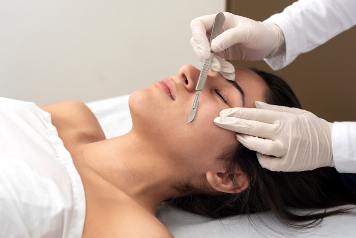Woman receiving a dermaplaning service in the spa