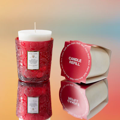 Voluspa offers 14 scents of the brand’s Japonica Collection in the Refillable Program. Voluspa Goji Tarocco Orange refillable candle shown.