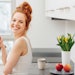 healthy-woman-redhead-eating-apple-in-white-kitchen