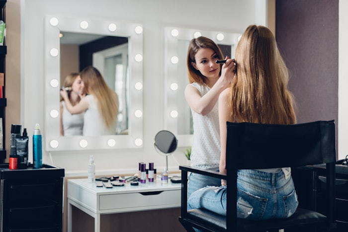 Makeup artist on site doing makeup