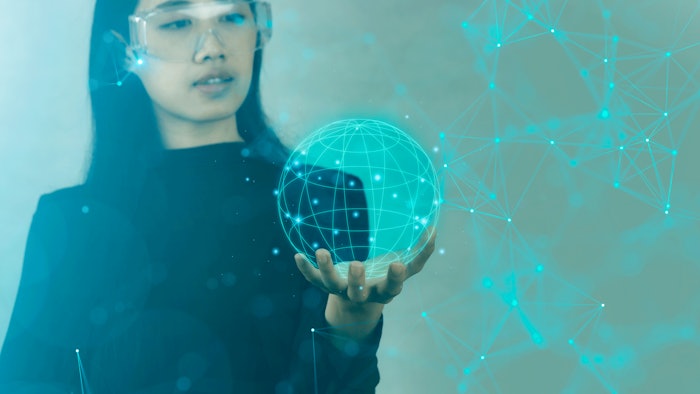 scientist holding digital depiction of globe with network connected