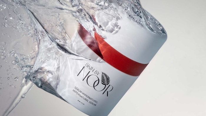 skin by Noor anti-aging serum in a jar splashing through water