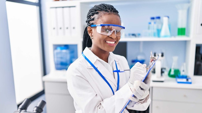 Woman Scientist In Lab With Clipboard Writing Notes Adobe Stock 604659319