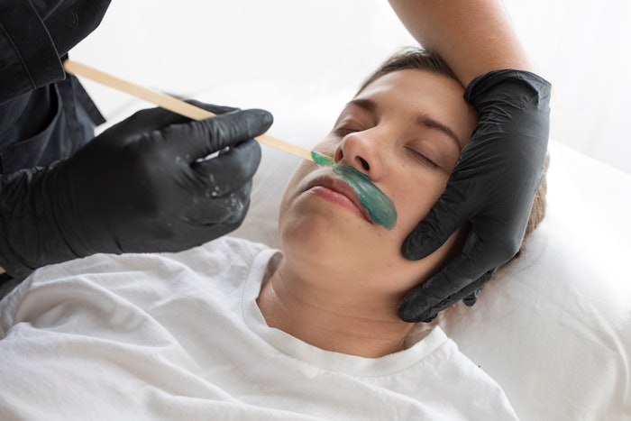 Woman getting her lip waxed at the spa