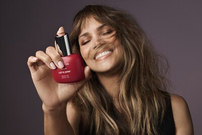 Halle Berry holding a bottle of Let's Spin Lubricant Gel