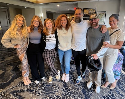 Beauty Launchpad Associate Managing Editor Gabby Bach poses with Olivia Thompson, Ivy Ann Miller and the Hairdustry and Industry Alligned teams at Beauty Gives Back.