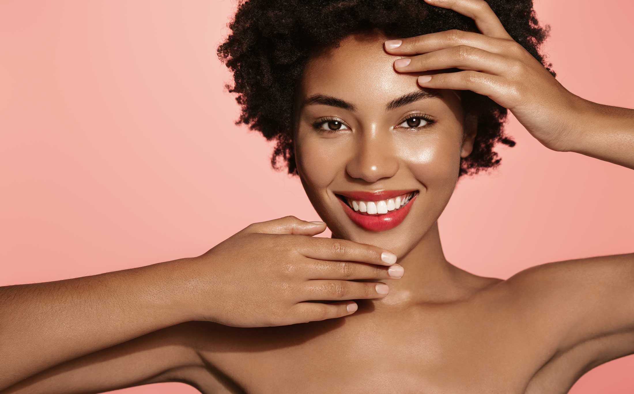 black woman young radiant skin smiling posing