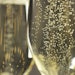 champagne in glasses bubbles up close