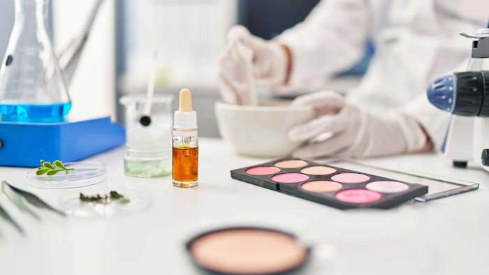 chemist in lab testing cosmetic products