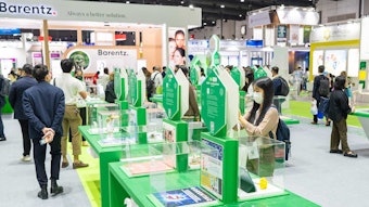people reviewing entries in the innovation zone glass cubes on pedestals with entries inside each