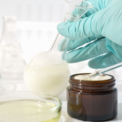 lab ferment jar gloved hand holding flask