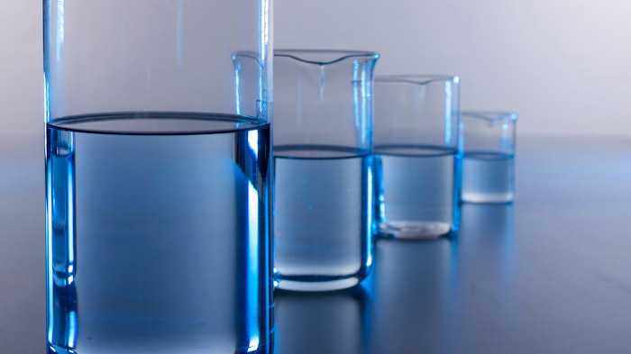 multiple beakers duplicates lined up with blue liquid in them