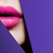 pink lips up close viewed through cut purple paper