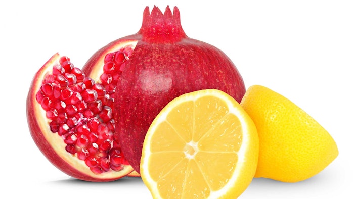 pomegranate and lemon whole and half fruits on white background