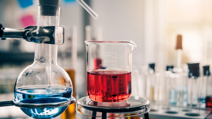 lab beaker and flask glassware setup with colored liquids