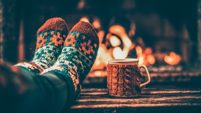 warm toasty socks on feet propped up by a fire with cocoa cup on the side