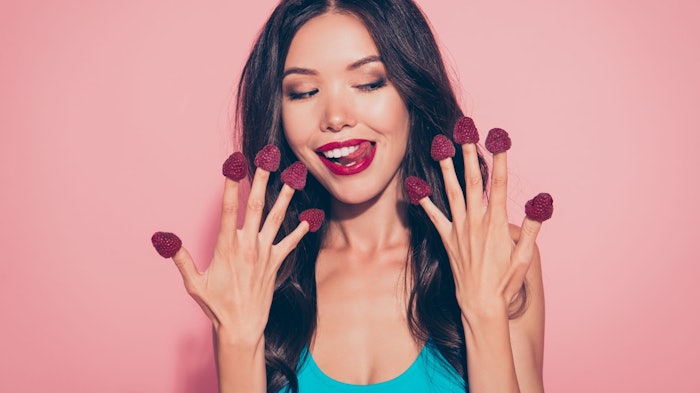 beautiful brunette berries on fingers smiling tasting