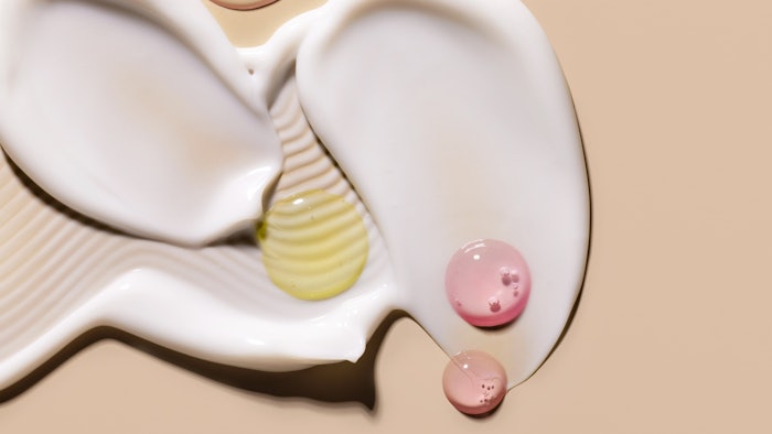 cosmetic blobs over each other on beige background