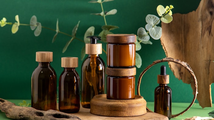 cosmetic products wooden packages green backdrop