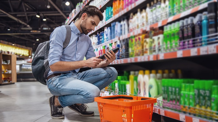 man shopping in supermarket personal care aisle