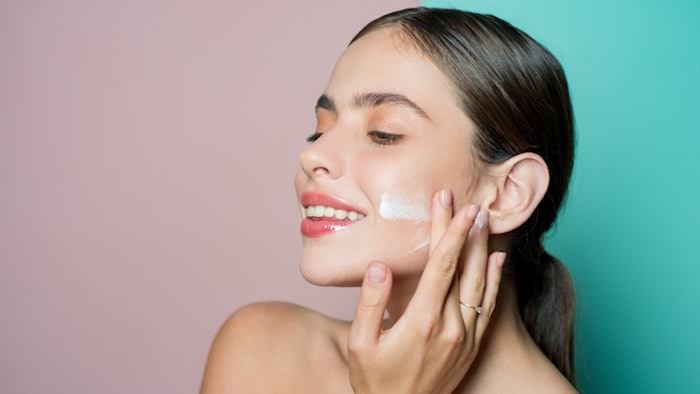 woman antiaging cream dual tone background