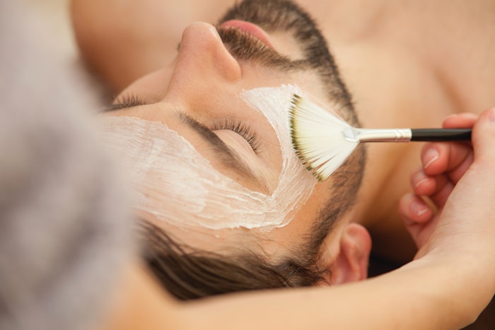 Man having a facial mask at the spa